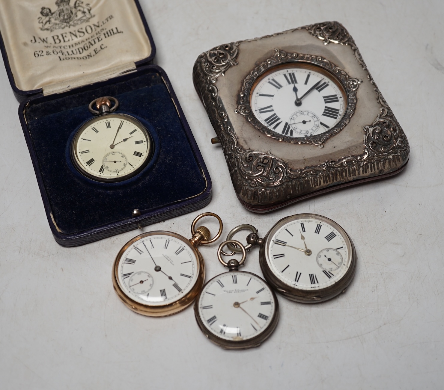 A George V repousse silver mounted travelling watch case (a.f.), with pocket watch, three silver open face pocket watches and a Waltham gold plated pocket watch. Condition - poor to fair